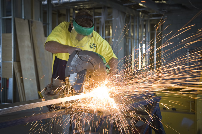 construction photography small feature image of worker cutting framework